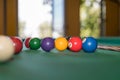 Billiard balls on the green pool table cloth, opposite the open window Royalty Free Stock Photo