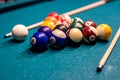 Billiard balls in a green pool table, ready for recreational activity