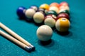 Billiard balls in a green pool table, ready for recreational activity