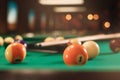 Billiard balls near by cue on the pool table.