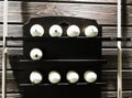 Billiard balls on the shelf with cues from both sides