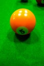 Billiard balls on table. Balls on green billiard table. Number 5.