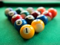 Billiard balls are in the triangle on the green table. Concept of billiard, pool or snooker matches Royalty Free Stock Photo