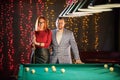 Billiard club. A nice pretty married couple standing by the table Royalty Free Stock Photo