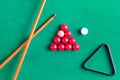 Billiard colorful balls with wooden cue on green table. Snooker, Pool game. Top view.