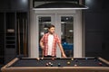 The billiard. Guy Playing billiards. Man hit ball in billiard in Billiard room. Russian pool billiards. Snooker Player Royalty Free Stock Photo