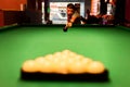 A billiard player breaks cue balls at the beginning of the game
