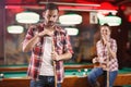 Billiard player rubs chalk his cue-young man plays billiard