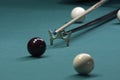 Billiard player striking a ball with cue stick using the rest Royalty Free Stock Photo