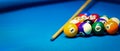 billiard pool balls rack and cue on the blue cloth table. copy space