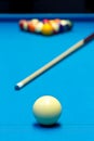 Billiard pool game eight ball setup with cue on billiard table