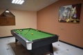 Billiard table with cue and balls. Green billiards background Royalty Free Stock Photo