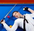 Billiard young man player lying on pool blue table Royalty Free Stock Photo