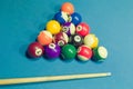 Billiards balls and cue on billiards table