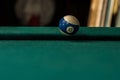 Billiards balls and cue on billiards table. Billiard sport concept.Ball in motion