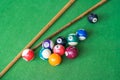 Billiards and pool cues on the pool table