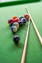 Billiards and pool cues on the pool table