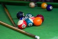 Billiards and pool cues on the pool table