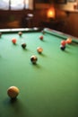 Billiards table with pool balls spread out.