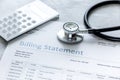 Billing statement for for medical service in doctor`s office background Royalty Free Stock Photo
