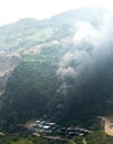 Billow of black smoke rising from traditional burning limestone kiln calcination process in factory