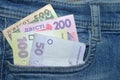 500, 200,100, 50 bills hryvnia  in the front pocket of blue jeans. Royalty Free Stock Photo