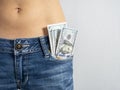 100 bills stick out of the front pocket of his jeans The concept of money in your pocket Royalty Free Stock Photo