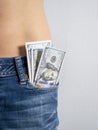 100 bills stick out of the front pocket of his jeans The concept of money in your pocket. vertical photo Royalty Free Stock Photo