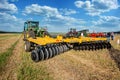 Bilogirya, Khmelnytsky region, UKRAINE - August 19, 2021: tractor with disc harrow in operation at the demonstration of
