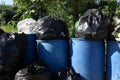 Bin, garbage bags, full bins waste plastic bags, garbage bag black full and blue tank bin, pollution trash plastic waste Royalty Free Stock Photo