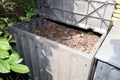 bin in the garden for Composting pile of rotting kitchen fruits and vegetable scraps