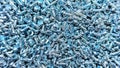A bin is overflowing with many small, silver screws, ready for use in construction or repair projects Royalty Free Stock Photo