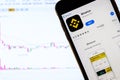 Binance cryptocurrency exchange logo and icon on Phone screen over a laptop display with bitcoin chart. Los Angeles, California Royalty Free Stock Photo