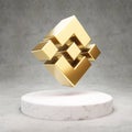 Binance cryptocurrency icon. Gold 3d rendered icon on white marble podium