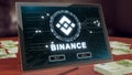 Binance cryptocurrency logo on the pc tablet display. Neon bright blockchain symbol