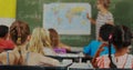 Binary code image over students in classroom with teacher pointing at world map Royalty Free Stock Photo