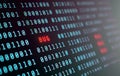 Binary code on screen with red glowing \
