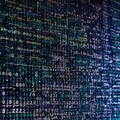 The binary values 0 and 1 are displayed with flowing letters on a technical background. Royalty Free Stock Photo