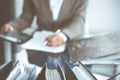 Binders of papers waiting to process by bookkeeper woman or financial inspector, close-up. Business portrait. Audit or