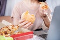 Binge Eating Disorder concept with woman over eating Fast Food Burgers and Pizza Royalty Free Stock Photo
