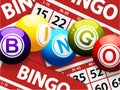 Bingo balls over red bingo cards Royalty Free Stock Photo