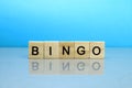 Bingo word made of wooden blocks on a blue background