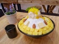 BINGSU Mango dessert popular.on wood table in the cafe