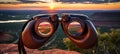 Binocular on majestic rock mountain summit at sunset with breathtaking scenic view