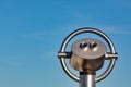 Binoculars with blue sky in the background - concept for business outlook or future perspective Royalty Free Stock Photo