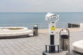 Binoculars with coin acceptor mounted on the observation deck on the beach