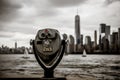 Binoculars in Ellis Island with view to Manhattan skyline new york