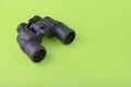 Binoculars on green background