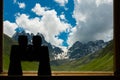 Binoculars lying on sill overlooking mountain. Royalty Free Stock Photo