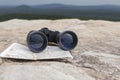 binoculars on the map. Lies on the top of the mountain, tourism travel, navigation, gps Royalty Free Stock Photo